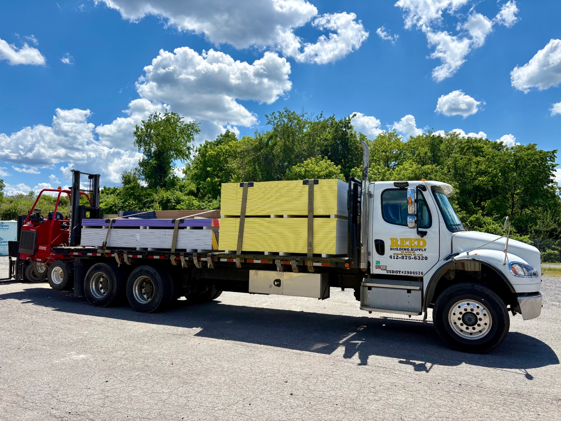 Reed Building Supply flatbed truck loaded with building materials