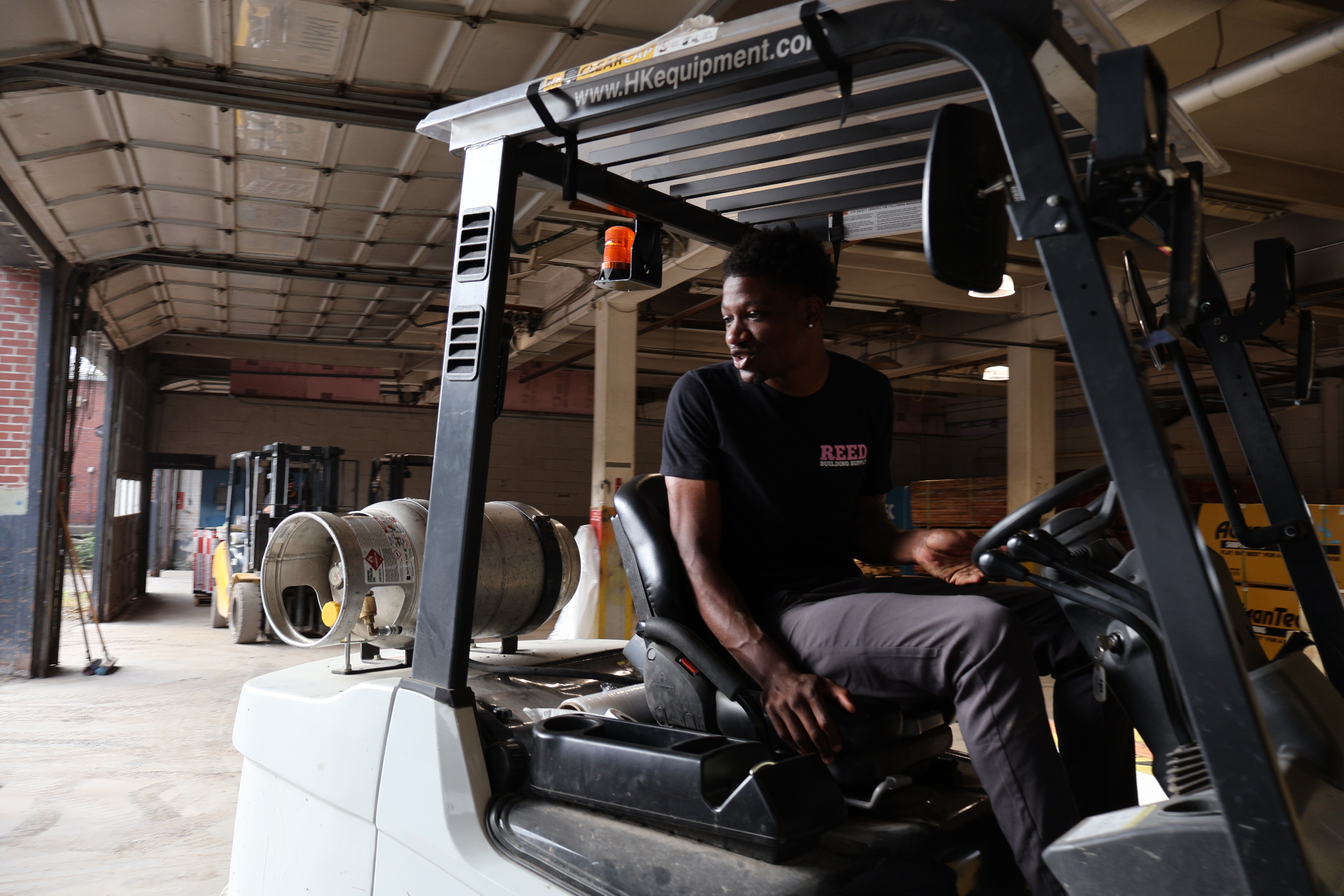 Reed team member operating a warehouse forklift