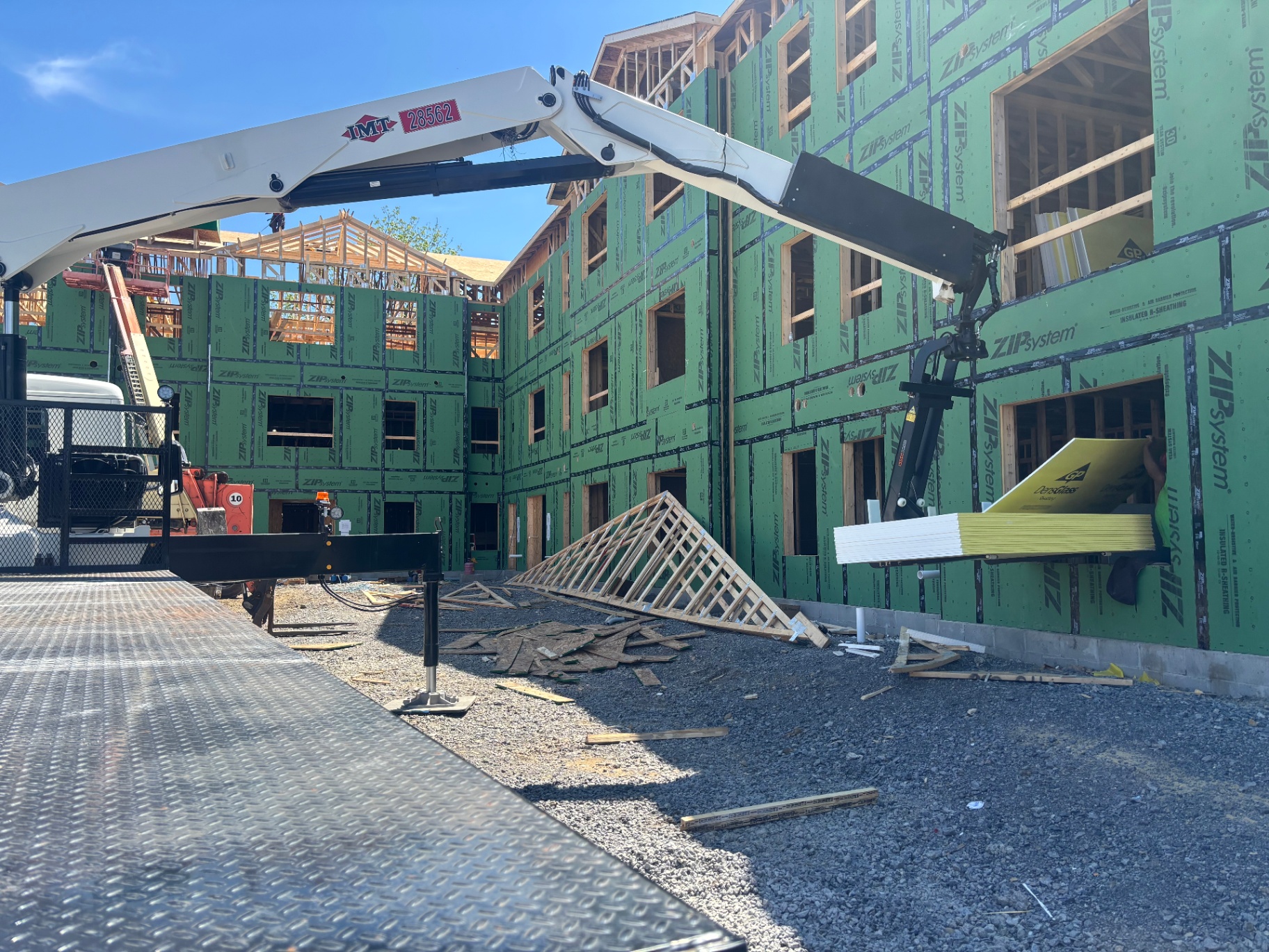 Boom truck delivering materials to a jobsite